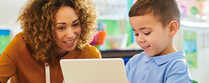 Teacher helping a young child with school work